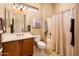 Well-lit bathroom with a single vanity, shower-tub combination, and tasteful decor at 22813 N Del Monte Dr, Sun City West, AZ 85375