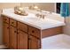 A bathroom vanity featuring a white countertop, wood cabinets, and a chrome faucet at 22813 N Del Monte Dr, Sun City West, AZ 85375