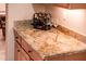 Wet bar featuring a stone countertop, wine rack, and wine glasses at 22813 N Del Monte Dr, Sun City West, AZ 85375