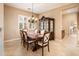 Elegant dining room featuring a chandelier, shuttered windows, and classic wood furniture at 22813 N Del Monte Dr, Sun City West, AZ 85375