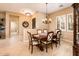 Elegant dining room featuring a chandelier, shuttered windows, and classic wood furniture at 22813 N Del Monte Dr, Sun City West, AZ 85375