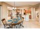 Open-concept kitchen and dining area with breakfast bar, ample cabinet space, and a view of the kitchen at 22813 N Del Monte Dr, Sun City West, AZ 85375