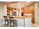 Well-lit kitchen featuring a breakfast bar with seating, stainless steel appliances, and modern cabinetry at 22813 N Del Monte Dr, Sun City West, AZ 85375