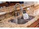 A stainless steel kitchen sink and faucet paired with elegant granite countertops at 22813 N Del Monte Dr, Sun City West, AZ 85375