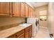 Well-equipped laundry room with ample storage, utility sink, and modern washer and dryer units at 22813 N Del Monte Dr, Sun City West, AZ 85375