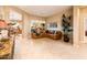 Warm living room featuring a large sectional sofa and a large window for natural light at 22813 N Del Monte Dr, Sun City West, AZ 85375