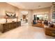 Comfortable living room featuring a large sectional sofa and a large window for natural light at 22813 N Del Monte Dr, Sun City West, AZ 85375