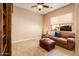 Comfortable living room features neutral colors, plush seating, and a ceiling fan for added comfort at 22813 N Del Monte Dr, Sun City West, AZ 85375