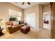 Cozy living room features neutral colors, plush seating, and an abundance of bright natural light at 22813 N Del Monte Dr, Sun City West, AZ 85375