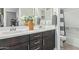 Bright bathroom with double sinks, dark wood cabinets, and modern fixtures at 22891 E Via Del Sol --, Queen Creek, AZ 85142