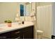 Bathroom boasts a dual-sink vanity with dark cabinets and framed mirror at 22891 E Via Del Sol --, Queen Creek, AZ 85142