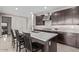 Modern kitchen island with quartz countertop, seating, and stainless steel fixtures at 22891 E Via Del Sol --, Queen Creek, AZ 85142