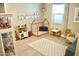 Bright playroom features a play kitchen, rug, daybed, and decor at 22891 E Via Del Sol --, Queen Creek, AZ 85142