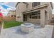 Landscaped backyard featuring a built-in firepit, turf, and neutral colored exterior at 2460 E Athena Ave, Gilbert, AZ 85297