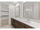 A primary bathroom features a double vanity, framed mirrors, and wood cabinets at 2460 E Athena Ave, Gilbert, AZ 85297