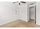 Neutral carpeted bedroom with ceiling fan, closet, and natural light at 2460 E Athena Ave, Gilbert, AZ 85297