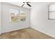 Bedroom with carpeted floors and natural light from multiple windows at 2460 E Athena Ave, Gilbert, AZ 85297