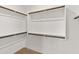 Walk-in closet with white shelving and wooden rails for maximum storage at 2460 E Athena Ave, Gilbert, AZ 85297