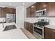 Detailed view of a modern kitchen featuring stainless steel appliances, tile backsplash, and ample countertop space at 2460 E Athena Ave, Gilbert, AZ 85297