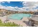 Community pool with lounge chairs and tables, perfect for relaxation and socializing at 2460 E Athena Ave, Gilbert, AZ 85297