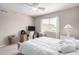 Bright bedroom featuring plush bedding, a ceiling fan, and a dedicated workspace for ultimate comfort at 250 W Queen Creek Rd # 240, Chandler, AZ 85248