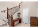 View of the entryway with stairs, tiled floors, and a wood console table at 250 W Queen Creek Rd # 240, Chandler, AZ 85248