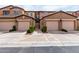 Exterior view of the townhome with attached garages and landscaped front yards at 250 W Queen Creek Rd # 240, Chandler, AZ 85248