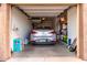 Organized garage featuring a parked car, storage shelves and various household items at 250 W Queen Creek Rd # 240, Chandler, AZ 85248