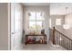 Well-lit hallway with staircase and a window that lets in natural light at 250 W Queen Creek Rd # 240, Chandler, AZ 85248