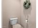 Toilet area featuring clean fixtures and a decorative wreath for a well-maintained space at 250 W Queen Creek Rd # 240, Chandler, AZ 85248