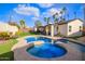 Wonderful backyard featuring pool, spa, covered patio, and lush landscaping perfect for relaxation at 2638 E Edgemont Ave, Phoenix, AZ 85008