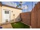 Backyard featuring an artificial lawn, a white door and a wooden fence at 2638 E Edgemont Ave, Phoenix, AZ 85008