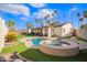 Inviting backyard with pool and spa, perfect for outdoor entertaining, surrounded by lush palm trees at 2638 E Edgemont Ave, Phoenix, AZ 85008