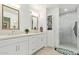 Well-lit bathroom featuring double sinks, new cabinet, updated shower, and modern finishes at 2638 E Edgemont Ave, Phoenix, AZ 85008