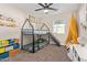 Fun bedroom featuring a house-frame bunk bed with a slide and a playful yellow canopy at 2638 E Edgemont Ave, Phoenix, AZ 85008