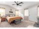 Spacious bedroom features soft carpet, a ceiling fan, and a large window for natural light at 2638 E Edgemont Ave, Phoenix, AZ 85008