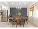 Dining area features a modern light fixture, wood table, and stainless-steel refrigerator at 2638 E Edgemont Ave, Phoenix, AZ 85008