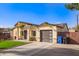 Inviting home featuring a well-maintained lawn, modern garage, and covered entrance at 2638 E Edgemont Ave, Phoenix, AZ 85008