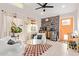 Cozy living room featuring white furnishings, tiled floor, and an orange entry door at 2638 E Edgemont Ave, Phoenix, AZ 85008