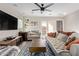 Bright living room with stylish decor, ceiling fan, and French doors to the patio at 2638 E Edgemont Ave, Phoenix, AZ 85008