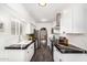 Well-lit kitchen with white cabinets, stainless appliances, black counters, and ample storage at 2824 N 42Nd Way, Phoenix, AZ 85008