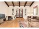 Inviting living room boasts a wood plank ceiling, neutral walls, wood floors, and floods of natural light at 2824 N 42Nd Way, Phoenix, AZ 85008