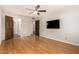 Main bedroom with wood floors, a ceiling fan, and a view of the bathroom at 2824 N 42Nd Way, Phoenix, AZ 85008