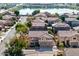 Neighborhood aerial view featuring a residential street, nearby lake and a home with modern architecture at 2977 E Teakwood Pl, Chandler, AZ 85249