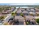 Scenic aerial view of a residential area showcases lush landscaping and a nearby lake at 2977 E Teakwood Pl, Chandler, AZ 85249