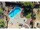 Aerial view showcasing a backyard oasis featuring a pool, lush landscaping, and a cozy outdoor fire pit at 2977 E Teakwood Pl, Chandler, AZ 85249