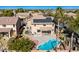 Backyard aerial view showcasing a private swimming pool, covered patio, and lush landscaping in a well-kept yard at 2977 E Teakwood Pl, Chandler, AZ 85249