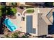 Aerial view of a property with a pool, patio, built in grill, small lawn, and solar panels for eco-friendly living at 2977 E Teakwood Pl, Chandler, AZ 85249