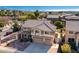 Aerial view of a home with a tile roof, desert landscaping, and a view of distant mountains at 2977 E Teakwood Pl, Chandler, AZ 85249