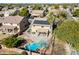 Backyard with a sparkling pool, spacious patio, mini golf, and lush landscaping; solar panels for energy efficiency at 2977 E Teakwood Pl, Chandler, AZ 85249